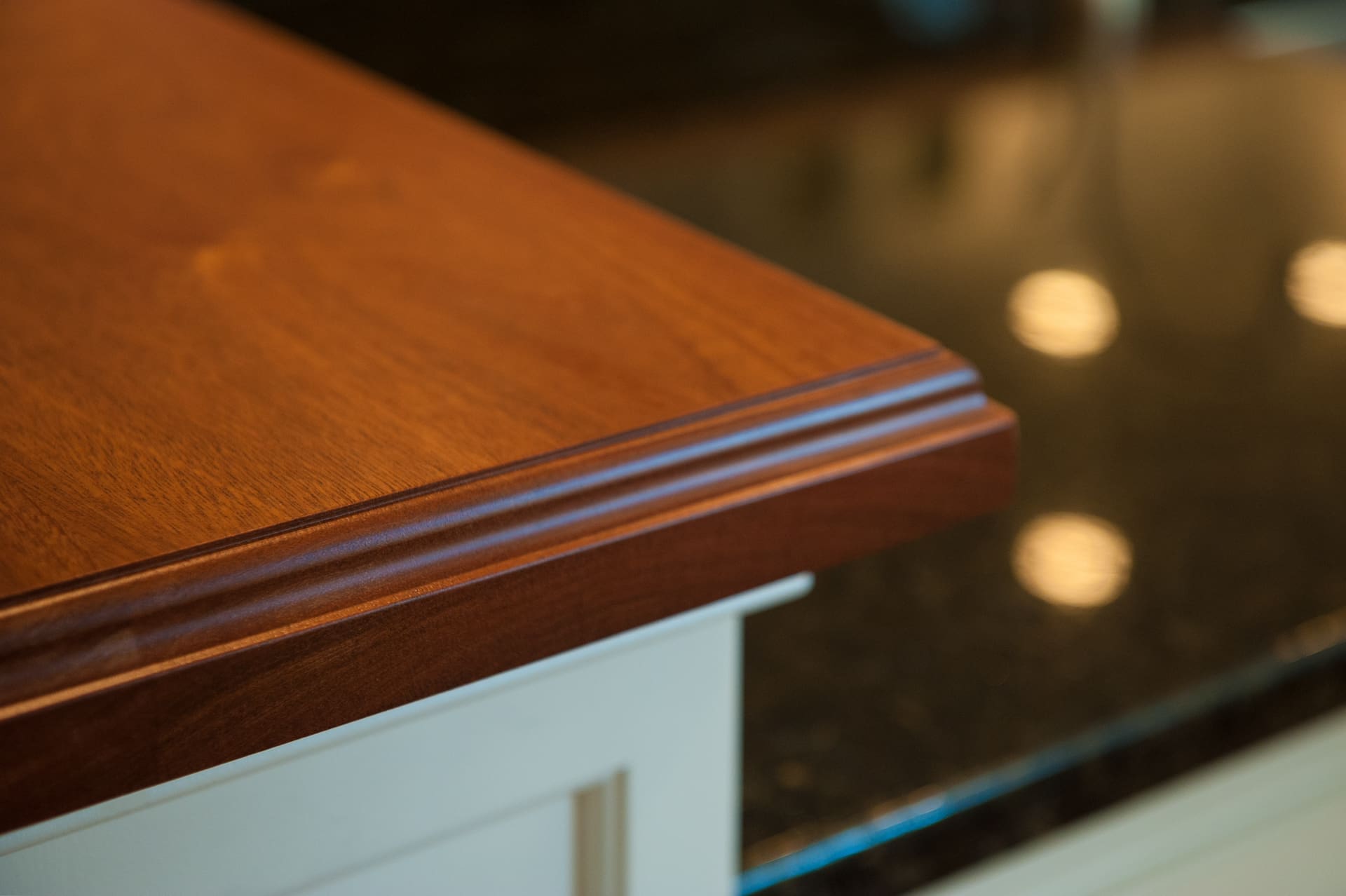 A photo of a wooden countertop with a decorative beveled edge.