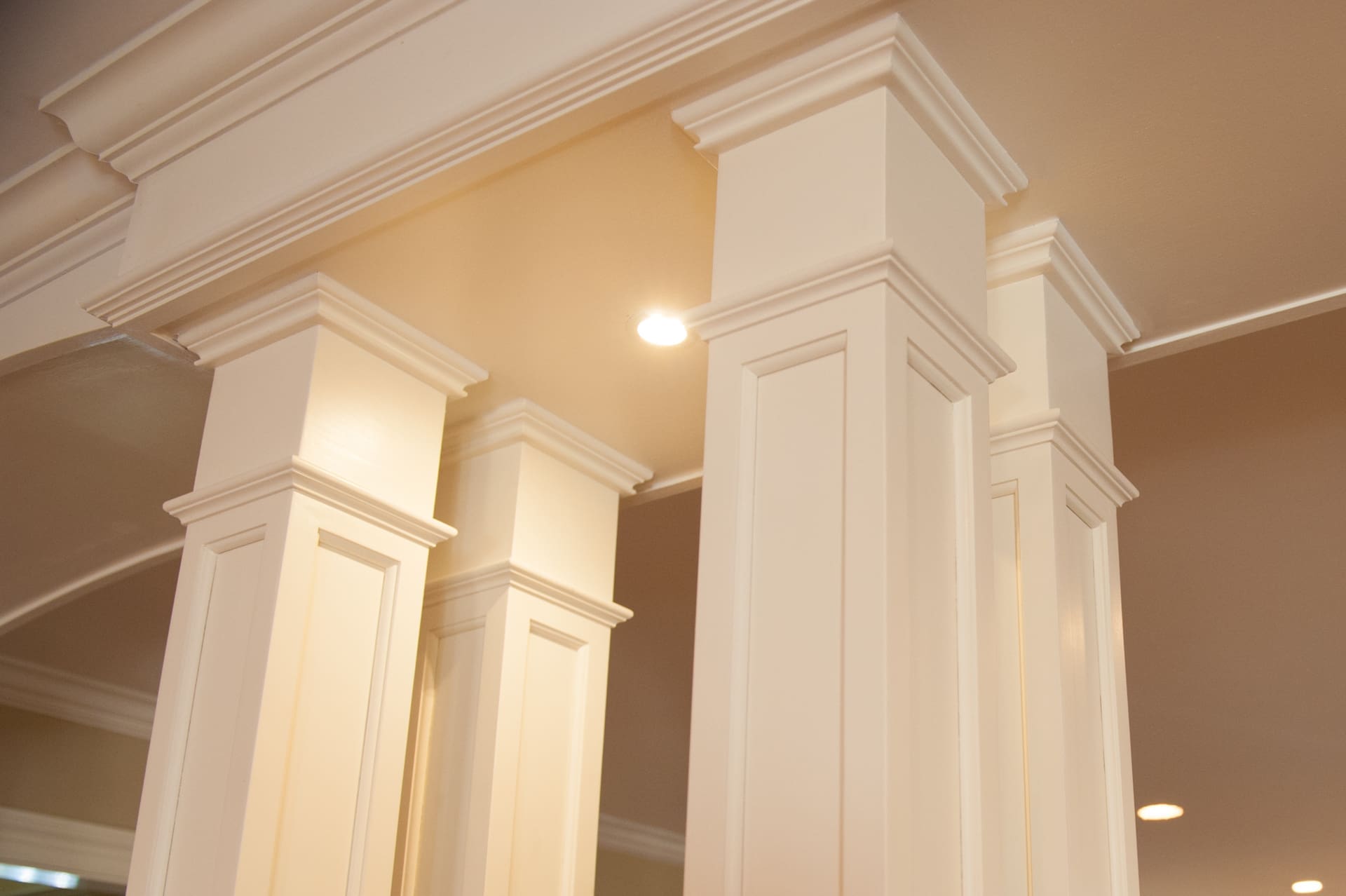 A photo of four white, shaker-style square columns.