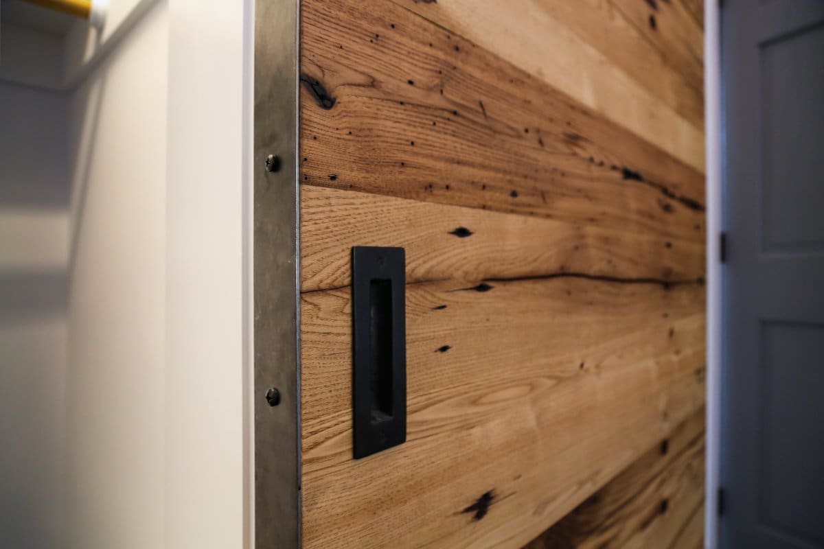 A photo of a wooden sliding door handle.
