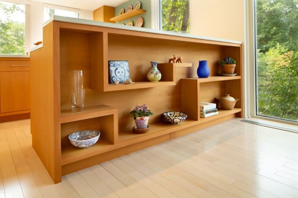 A photo of a geometric wooden built-in shelving in a kitchen island.