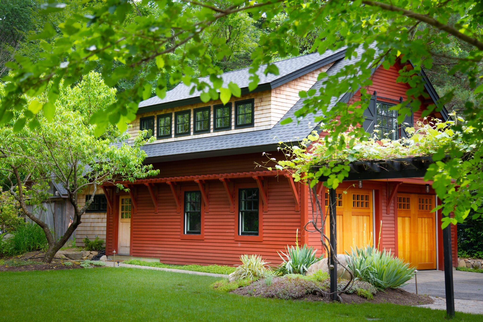 A red house with green roof and yellow door.