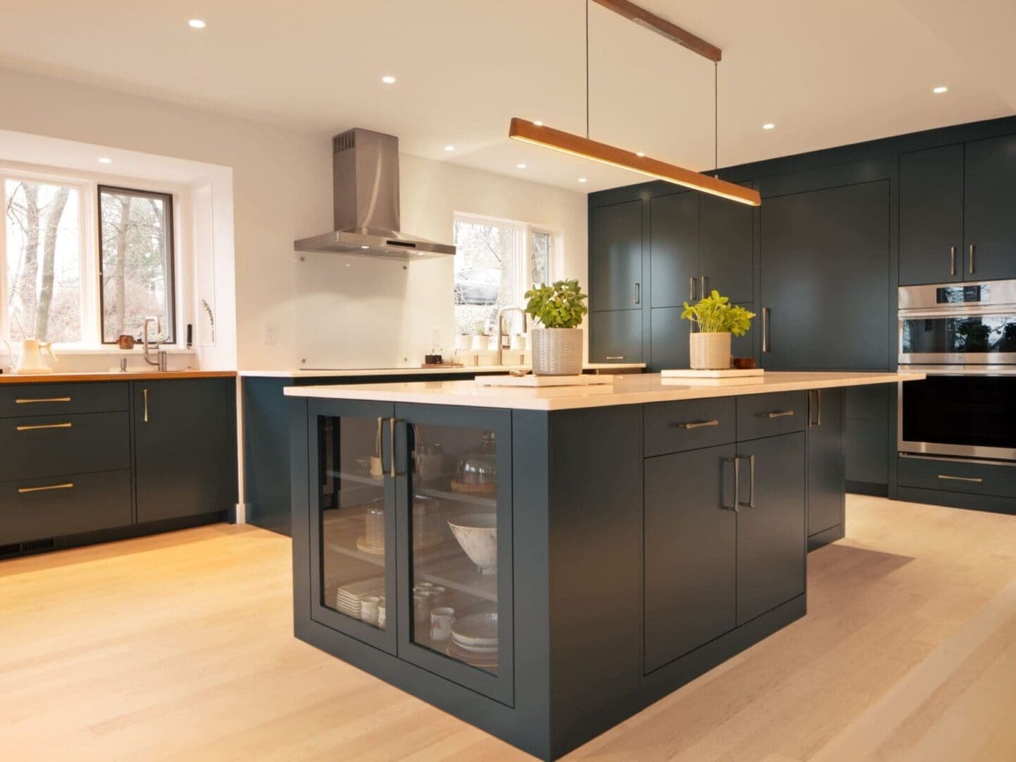 Modern dark green kitchen island and cabinets.