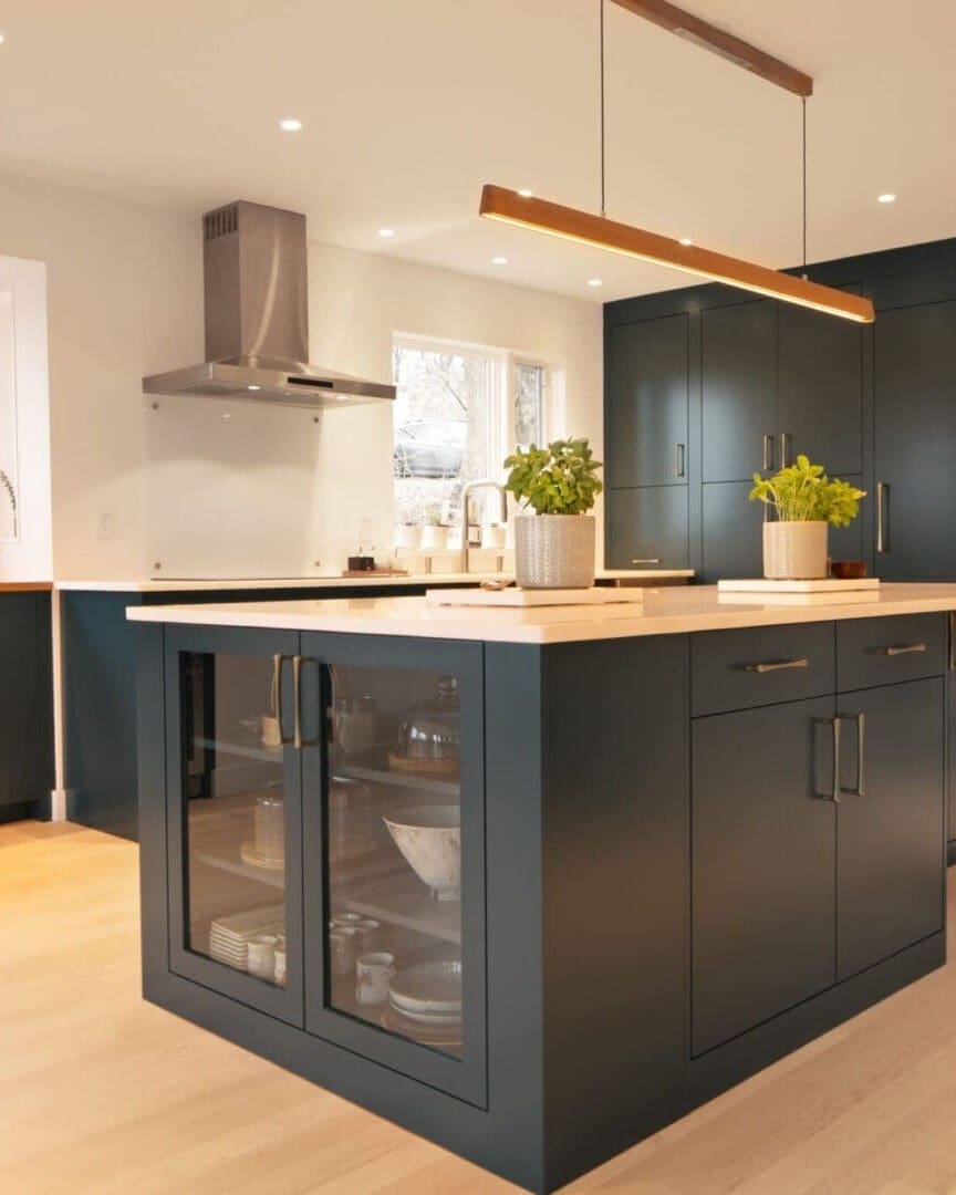 Modern dark green kitchen island and cabinets.